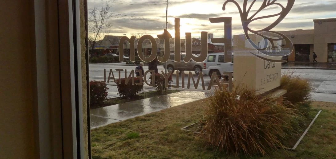 Fulton Family Dental sign at sunset
