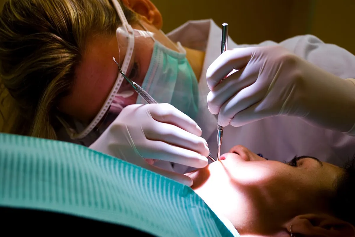 Dental professional performing a gentle teeth cleaning